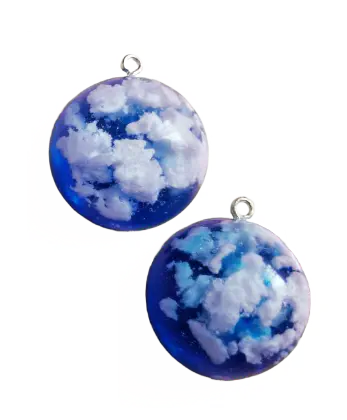 Two resin charms with a sky-blue gradient and fluffy clouds inside.