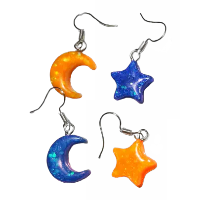 Two sets of glittery earrings. One pair is a yellow star and blue moon. The other pair is a blue moon and yellow star.