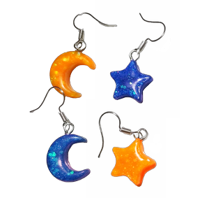 Two sets of glittery earrings. One pair is a yellow star and blue moon. The other pair is a blue moon and yellow star.