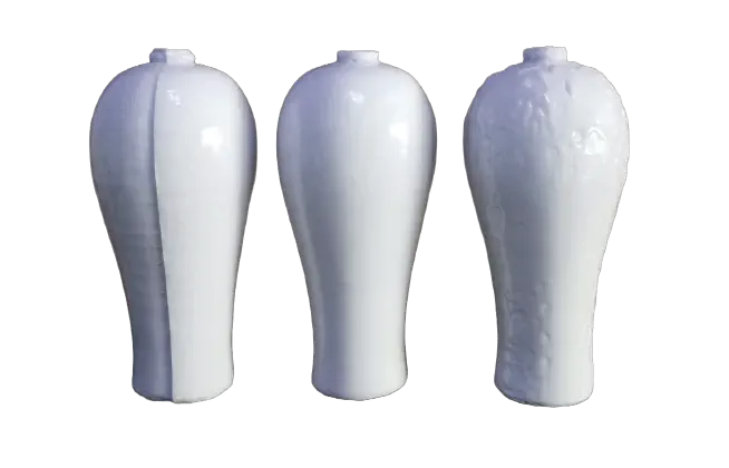 3 vases stand side-by-side, all nearly identical. The middle one is the most 'normal'. The left one is off-center, the two halves not joining flush. The right looks like its glaze is melting.